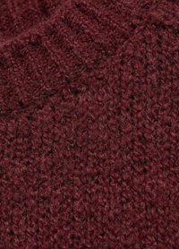 Burgundy knitted fabric with a soft, textured finish. Features a chunky weave pattern and slight variations in yarn thickness.