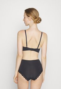 Black bra and high-waisted panties set featuring smooth fabric, adjustable straps, and lace trim along the leg openings.