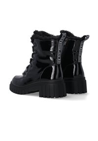 Black patent leather boots with faux fur lining, thick rubber soles, and lace-up design. Features a zip closure and logo accents.