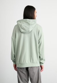 Nike Sportswear CLUB OVERSIZED - Džemperis ar kapuci - jade horizon/white