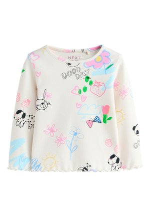 Camiseta blanca de manga larga para niños con garabatos coloridos que incluyen perros, flores, corazones, fresas, un sol y el texto "BUEN DÍA".