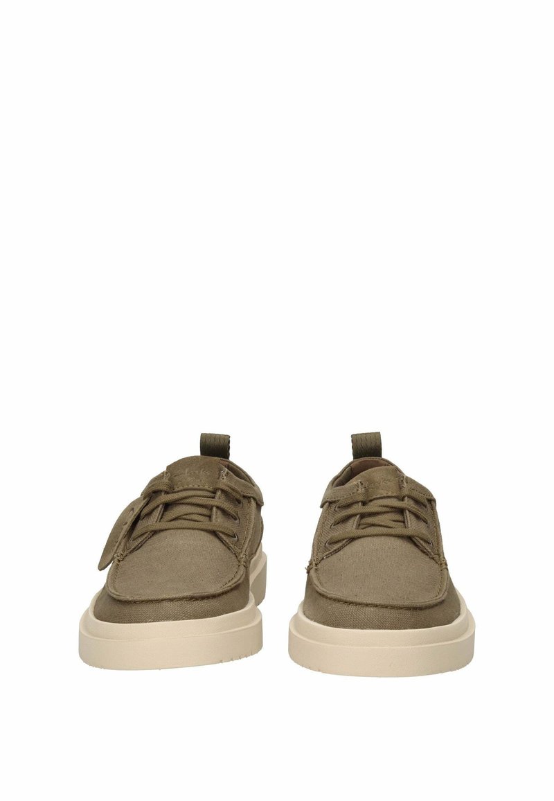 Paire de chaussures décontractées en toile vert olive avec semelles épaisses en caoutchouc beige, vue de face sur fond blanc.