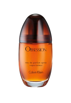 Amberfarvet glas parfume flaske med mørkebrun hætte mærket Obsession eau de parfum spray af Calvin Klein.