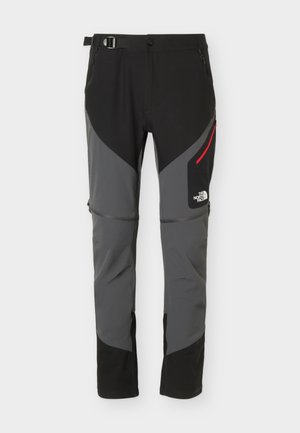 Czarno-szare spodnie turystyczne na zewnątrz z regulowanym paskiem w talii, kieszeniami na zamek oraz logo The North Face na prawej udzie.