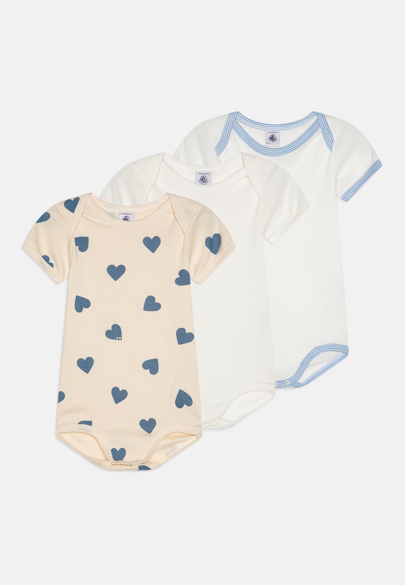 Three baby bodysuits: one peach with navy heart print, one plain white, and one white with blue striped accents on the neckline.