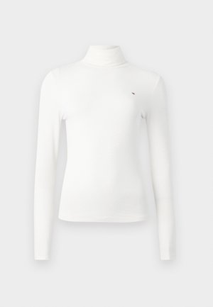 Hvit langermet turtleneck-genser laget av ribbestrikket stoff, med en liten logodetalj og slank passform.