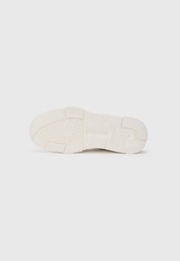 White sneaker sole with textured rubber, featuring grip patterns and branding. Smooth finish with a rounded shape and reinforced edges.