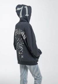 Dark gray hoodie with large white numeral "71" on the hood and intricate graphic featuring a dragon and roses on the back.