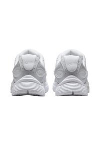 Baltas sporta kurpes ar teksturētu augšdaļu, mīkstinātu zoli un izteiksmīgu papēža dizainu. Aizmugurē nav redzamu zīmolu.