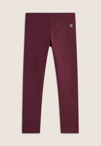 Leggings color bordeaux realizzati in un tessuto strutturato, con una vita alta e un piccolo tag con logo. Il design presenta un motivo esagonale su tutta la superficie.