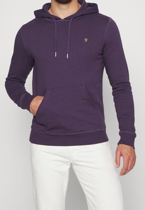 Felpa viola realizzata in tessuto morbido, con tasca anteriore, cappuccio con cordoncino, polsini a costine e un piccolo logo ricamato sul petto.