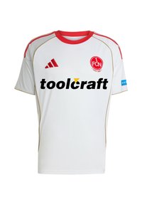 Biała koszulka piłkarska z krótkim rękawem, z czerwonymi akcentami i złotymi wykończeniami. Zawiera dużą czarną logo "toolcraft" oraz emblemat drużyny na klatce piersiowej.