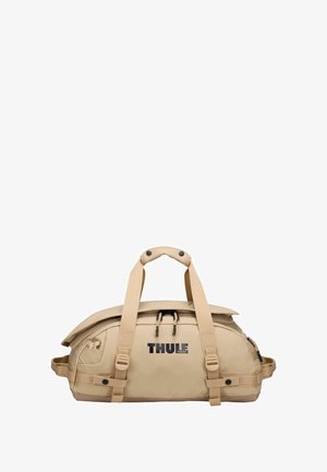 Borsa da viaggio Thule in colore beige, realizzata in materiale impermeabile. Presenta manici doppi, spallacci regolabili e scomparti con cerniera. Dettaglio del logo semplice.