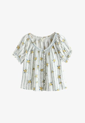 Valkoinen pusero, jossa on siniset pystysuorat raidat ja keltainen kukkakuvio, hieman pökätyt lyhyet hihat, edessä napitettava suljenta ja kerätty pääntie.