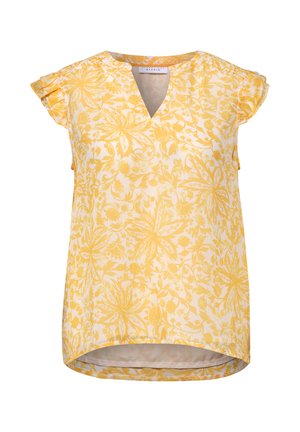Blouse jaune à fleurs à manches courtes avec col en V et détails à volants sur les manches, présentant une coupe asymétrique (ourlet haut-bas).