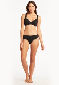 Czarny zestaw bikini z formowanym stanikiem na szerokich ramiączkach i wysokim stanem na dolnych częściach. Gładka faktura, minimalistyczny design i brak wzorów.