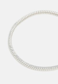 Silver bracelet with a flexible design, featuring interconnected oval links and a polished, textured finish. Circular shape.