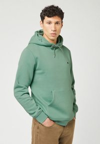 Green hoodie made from cotton, featuring a front pocket, adjustable hood with patterned drawstrings, and elastic cuffs.