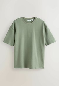 T-shirt vert clair à manches courtes en maille texturée avec col rond, présenté sur un fond clair uni.
