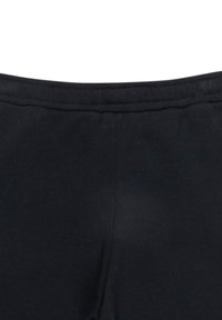 Svarta tights har en slät yta, elastisk midja och minimal sömdetalj längs toppen. Inga ytterligare mönster eller metalldelar synliga.