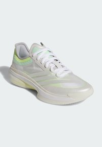 Light gray and pastel green athletic shoe with white laces and a cushioned sole, photographed against a plain light background.