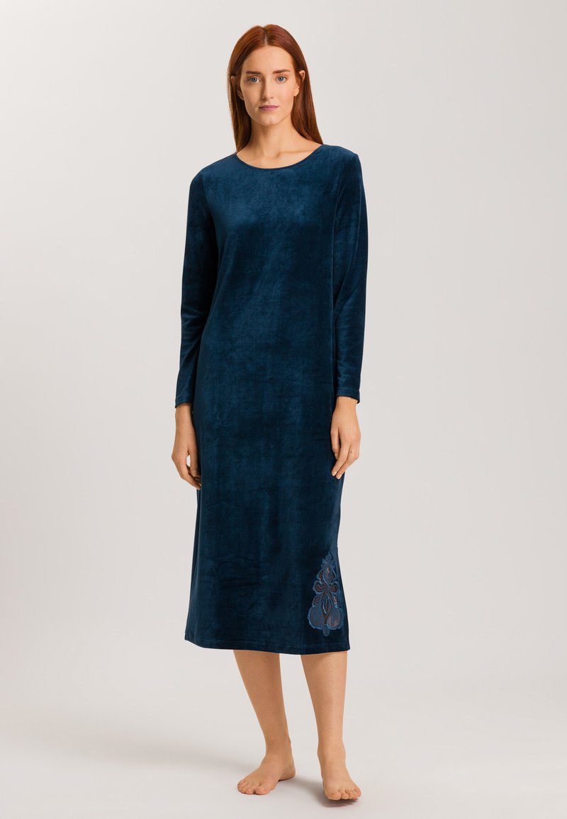 Mörkblå velour nattklänning med lång ärm, rund halsringning och blommönsterbroderi nere till vänster. Mjuk och slät textur.