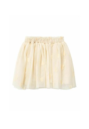 Jupe en tulle couleur crème jusqu’aux genoux avec taille élastiquée froncée et petites applications en forme de cœur sur tout le tissu.