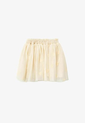 Jupe en tulle couleur crème jusqu’aux genoux avec taille élastiquée froncée et petites applications en forme de cœur sur tout le tissu.