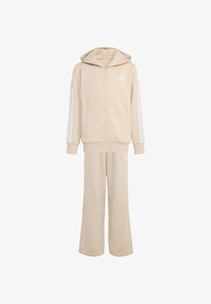 Bežová mikina na zips s kapucňou a bielymi bočnými pruhmi, doplnená o zodpovedajúce bežové tepláky. Obsahuje logo Adidas v bielej farbe.