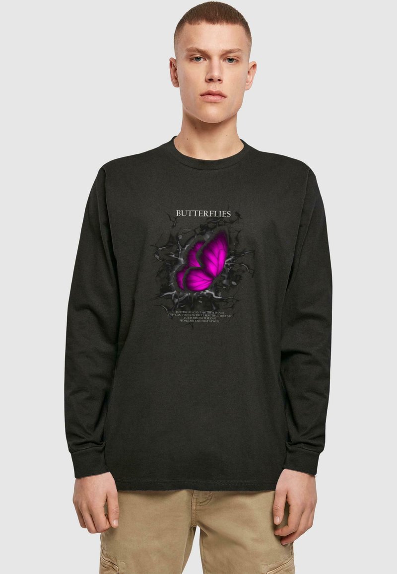 Sort langærmet t-shirt med et stort lilla sommerfuglediagram med en sprukken baggrund og teksten "SOMMERFUGLE."