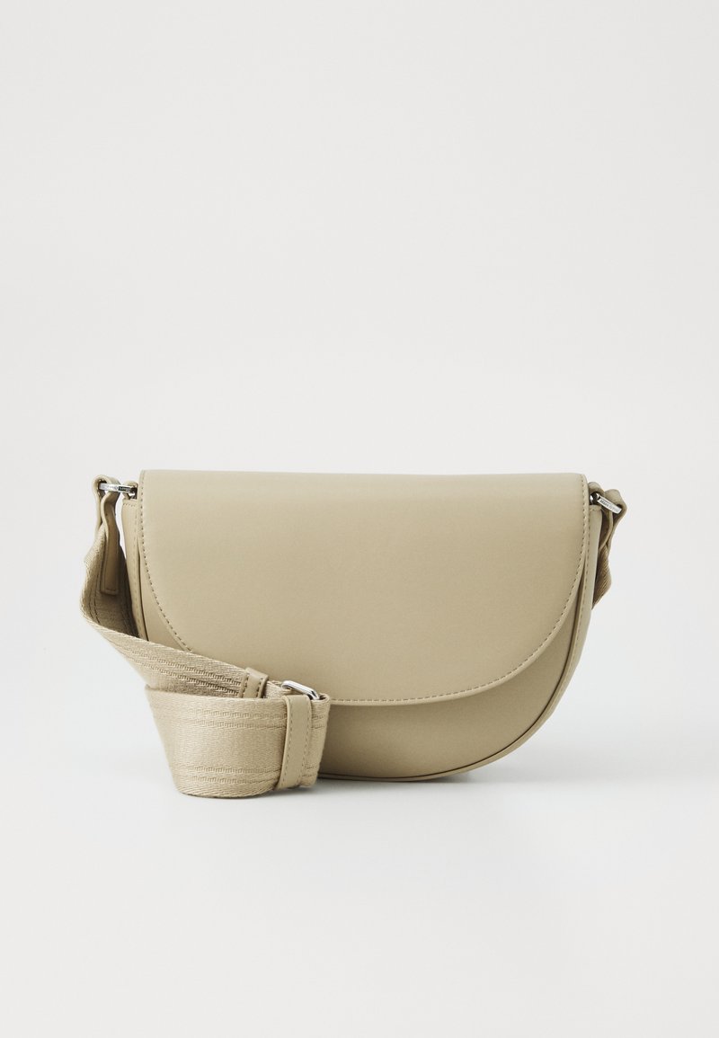 Beige crossbody bag made of smooth synthetic material, featuring a rounded flap, adjustable strap, and a secure metal clasp.