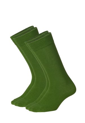 To par ensfarvede grønne strømper i mandslængde med ribbede manchetter, vist side om side på en hvid baggrund.