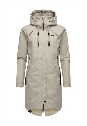 Long beige waterproof coat with a hood, adjustable drawstrings, side pockets, and a zip closure. Features a sleek, minimalistic design.