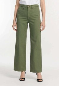 Groene wijdvallende jeans van katoen-twill stof, met een hoge taille, knoopsluiting en naden langs de benen.