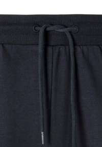 Schwarze Sweatpants mit einem gerippten Bund, verstellbarem Kordelzug und einer weichen Textur. Enthält silberne Beschläge an den Enden des Kordelzugs.