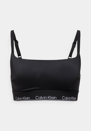 Svart sports-BH med justerbare stropper, glatt stoff og bredt bånd med hvit "Calvin Klein"-logo. Enkel, minimalistisk design.