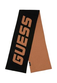Écharpe noire et couleur rouille avec le logo « GUESS » en grandes lettres capitales, fabriquée en tissu doux, présentant une texture lisse et une forme rectangulaire.