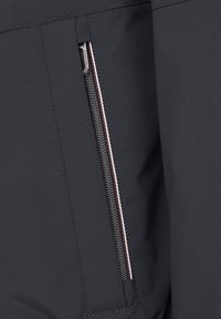 Black fabric featuring a zippered pocket with metallic zipper and contrasting colored stitching details. Smooth texture with minimal design elements.