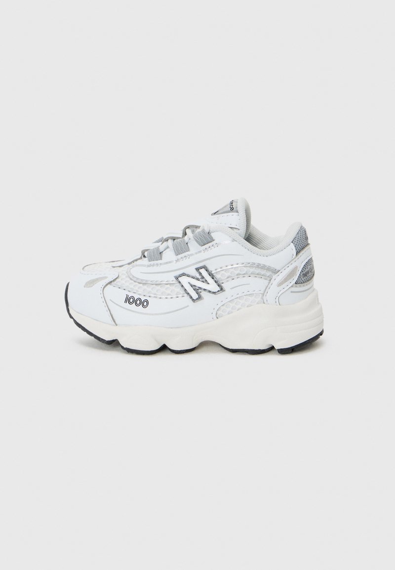 White New Balance sneakers feature a mesh and synthetic upper, cushioned sole, gray accents, and a prominent "N" logo on the side.