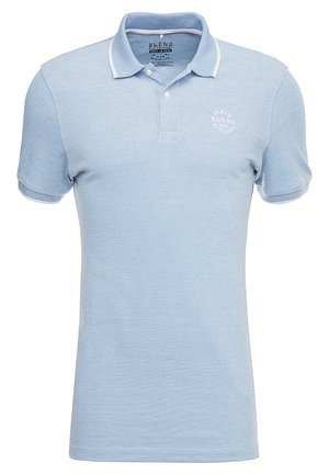 Light blue polo shirt made from textured fabric, featuring a classic collar, short sleeves, and a small white logo on the chest.