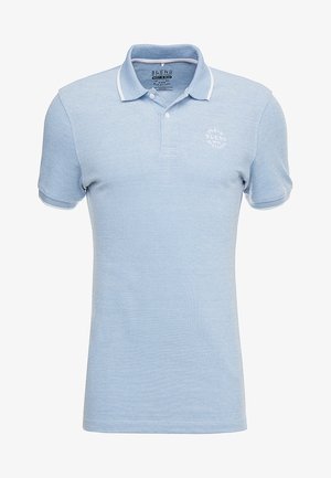 Light blue polo shirt made from textured fabric, featuring a classic collar, short sleeves, and a small white logo on the chest.