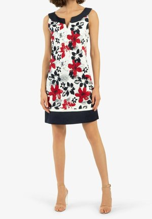 Sukienka bez rękawów z białej tkaniny w czerwono-czarny kwiatowy wzór. Posiada granatowy kołnierz i dolny pas. Krój w linii A.