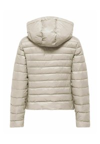 Vates jaka gaiši bēšā krāsā ar horizontālu šuvumu, kapuci un elastīgām aprocēm; izgatavota no gluda, dūraiņu materiāla siltināšanai.