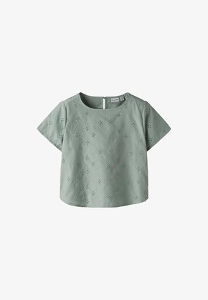 Kortærmet, mintgrøn bluse med blomsterbroderi, rund halsudskæring og en nøglehulåbning bagpå. Blødt stoftekstur.