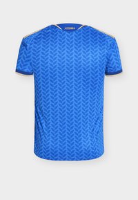 Blue sports jersey with a dark blue leaf pattern, gold trim on sleeves and shoulders, and "AZZURRA" printed near the collar on the back.