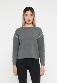 Gray sweater with long sleeves featuring white stitching along the shoulders. Soft texture, round neck, and a slightly cropped hem.