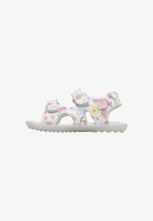 Sandalo bianco per bambini con stampe floreali rosa, gialle e blu e due cinturini regolabili in velcro su una suola bianca.