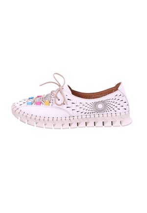 White lace-up shoe with patterned cutouts, colorful accents, a textured toe cap, and a segmented sole for flexibility.