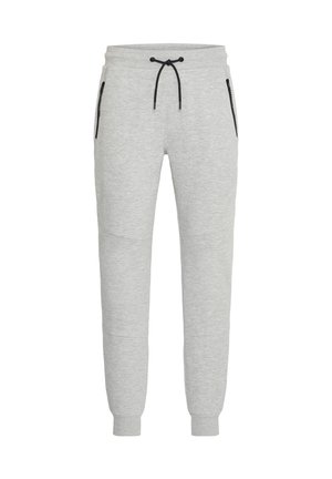Grijze trainingsbroek van zacht materiaal met een trekkoord in de taille, taps toelopende pijpen en zwarte ritszakken aan de zijkanten.