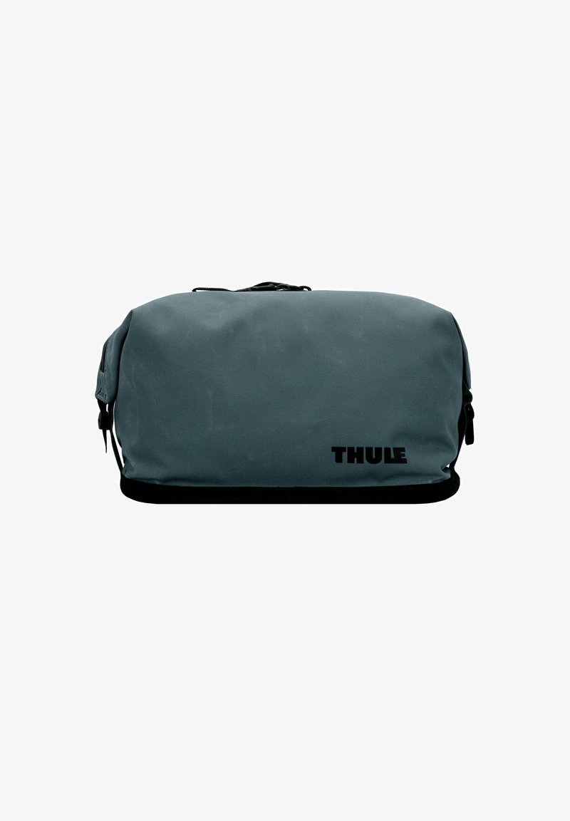 Sac de toilette de voyage rectangulaire gris compact Thule avec fermeture éclair noire et logo sur fond blanc.